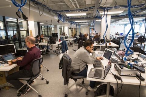 People using computers in UNH interoperability laboratory